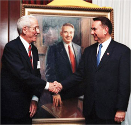 Artist and governor shaking hands at the portrait unveiling.