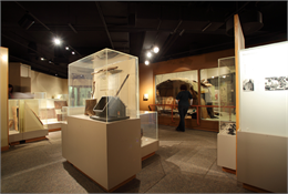 Visitor looking at Native American artifacts in an exhibit case.