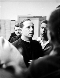 Father James Groppi in the midst of a group of people.