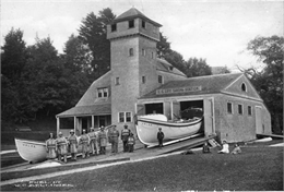 Exterior of boat house with crew.