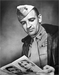 Joseph R. McCarthy in his Marine Corps uniform at the time of his first campaign for the United States Senate. He is holding a piece of his campaign literature.