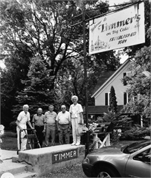 Five people are posing outside Timmer's Restaurant before going in for a fish-fry dinner.