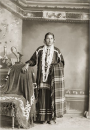 Standing portrait of a Ho-Chunk woman in native dress.