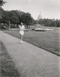 Proxmire jogging in a park near the U.S. Captiol.