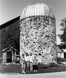 The Todd Bodden family poses by this wonderful, old silo, which was built in 1910.