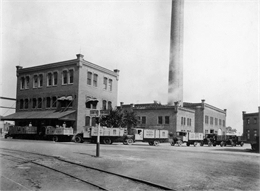 Horlick's Malted Milk Corporation depot with receiving trucks.