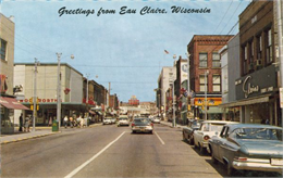 View down street of the downtown business district, including Woolworth's (left side) and Astor's Rexall Drug Store (right side).