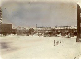 Wolf River Dam with ice and snow. Houses are in the background.