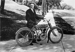 Walter Davidson posing with his motorcycle after winning the Endurance Race in 1908.