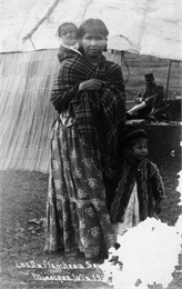 A Chippewa mother with two children at Minocqua, Wisconsin. This image is part of an exhibit about Native Americans prepared by Paul Vanderbilt, the first curator of photography at the Wisconsin Historical Society.