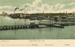 Elevated view of East Green Bay, Fox River, and various buildings belonging to the manufacturing industry.