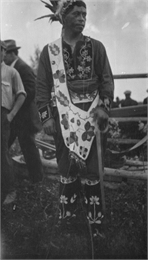 Native American at a Red Cliff Indian Reservation Powwow on the shores of Lake Superior. Wearing full regalia and beaded bandolier bag.