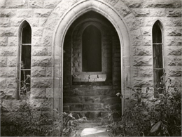 An exterior view of the rear doorway to the Banjamin Walker Castle, 1862-1893 in the 900 block of East Gorham Street.