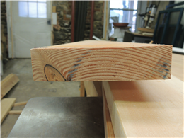 photo of a plain sawn fir board with a cup and twist.