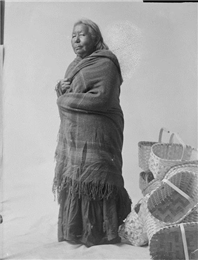 Ho-Chunk woman with multiple woven baskets