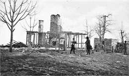 Men clear the ruins of a home after the Battle Above the Clouds.