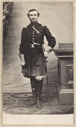 Full-length carte-de-visite portrait of Lieutenant Carlos W. Wellman (or Willman), Companies A and K, 37th Massachusetts Infantry, standing in full uniform grasping his sword.