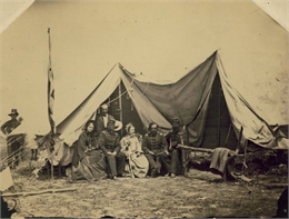A group of people at the headquarters tent of the 2nd Wisconsin Infantry