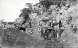 Black and White photograph of well-dressed men and women visiting the Iron Ridge mine.