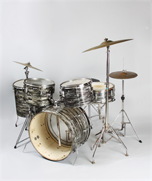 Drum set photographed against a grey backdrop.