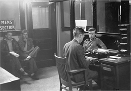 Men looking for a job during the Great Depression wait their turn in the Employment Office.