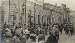 Photograph showing people at a train station near