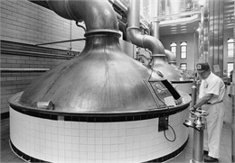 Richard A. Schulz checks a kettle of beer brewing at the Pabst Brewery.