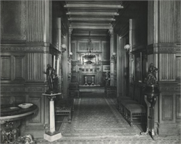 Interior of home. Hall lined with upholstered benches and art work.