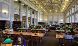 View of the Society's two-story library with students reading at tables.