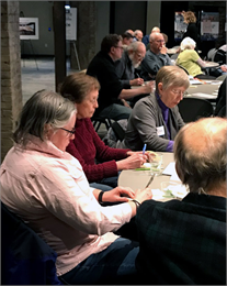 Guests write down their thoughts on Post-It notes for an exercise during the Wisconsin Historical Society's "Share Your Voice" new museum listening session Feb. 21, 2019 at the Goodman Community Center in Madison.