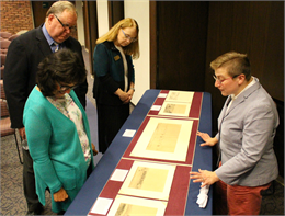 Lisa Saywell, of the Wisconsin Historical Society's Library and Archives, right, talks about one of the rare artifacts brought to La Crosse: Several frames from the only remaining original 1849 sketches of the Oregon Trail by artist James F. Wilkins.