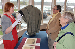 Simone Munson, Collection Development Coordinator for the Wisconsin Historical Society, tells guests about a shawl worn by Abraham Lincoln, one of several rare objects brought to the "Share Your Voice" listening session in Hudson.