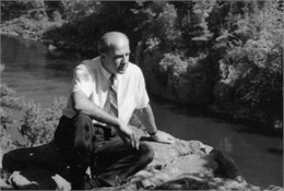 Gaylord Nelson seated on a rock overlooking the St. Croix River