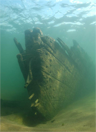 An underwater photo of a submerged ship in shallow water.