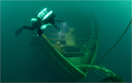 a scuba diver documents the shipwreck SS Wisconsin