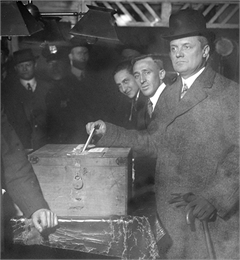 New York Governor Charles Seymour Whitman votes using a similar simple wooden ballot box, 1915-1918