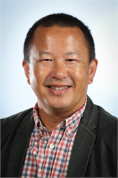 Photo portrait of Pao Lor wearing checked button-down and jacket