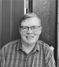 Black and white photo portrait of Jeff Kannel wearing a plaid shirt