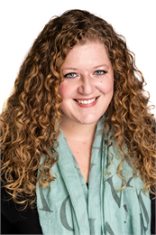 Photo portrait of Kristen Whitson wearing a blue scarf