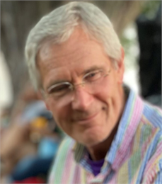 Headshot of Mike Hoeft wearing a collared shirt and glasses