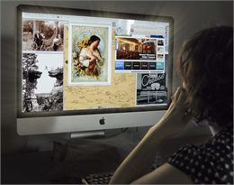 A researcher looks at a computer screen filled with six historic images from the Society's collections.