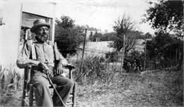 Thomas Green sitting in a rocking chair.